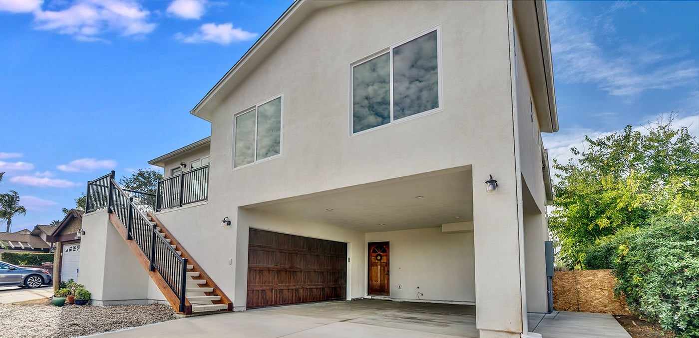 Attached ADU built above a garage in Mira Mesa, with an exterior staircase to its entry deck