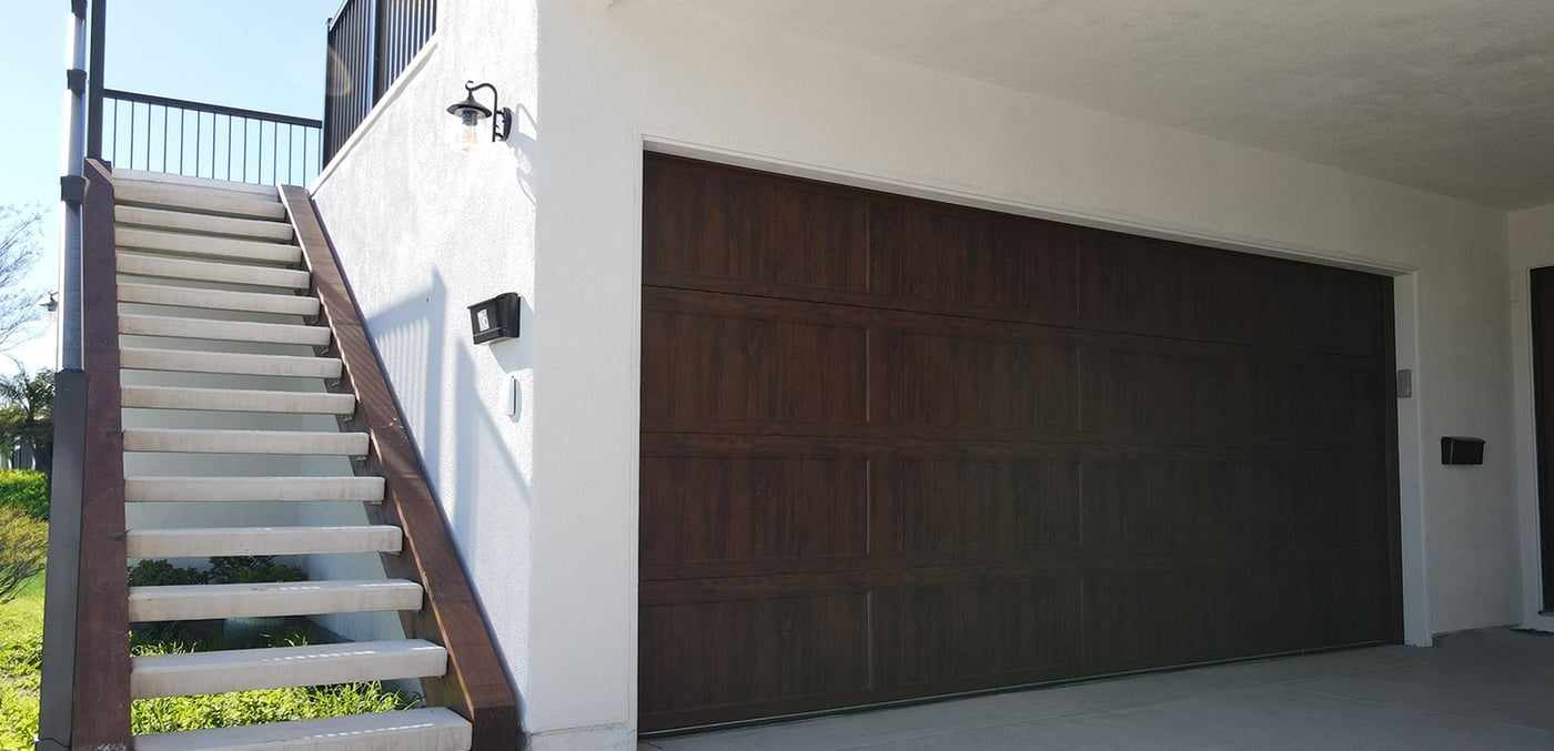 Exterior staircase beside the new garage door below the attached ADU in Mira Mesa