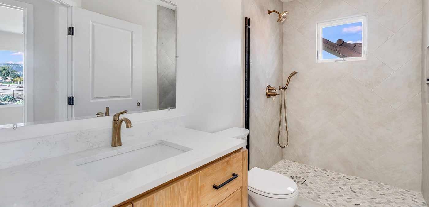 ADU bathroom with a walk-in shower and a window