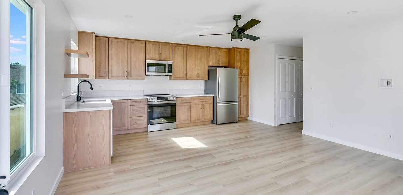 Open ADU living area and kitchen with wood cabinets