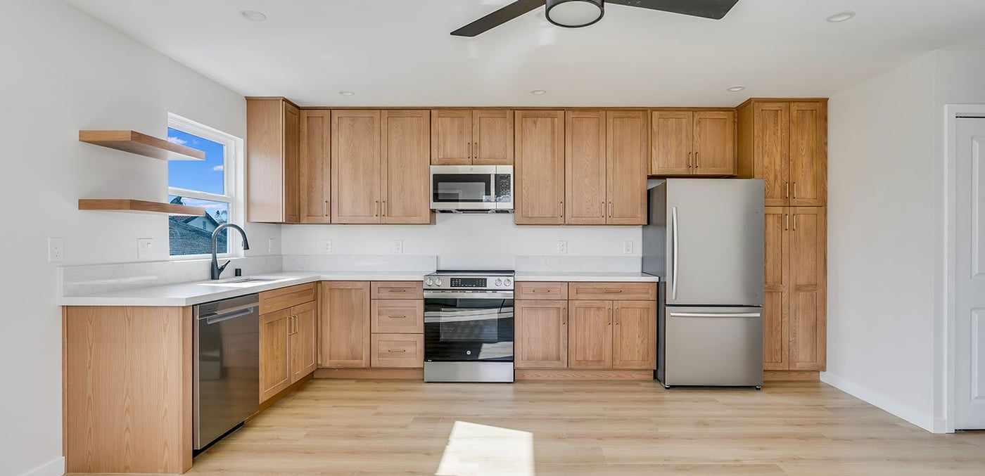 ADU kitchen with wood cabinets and stainless steel appliances