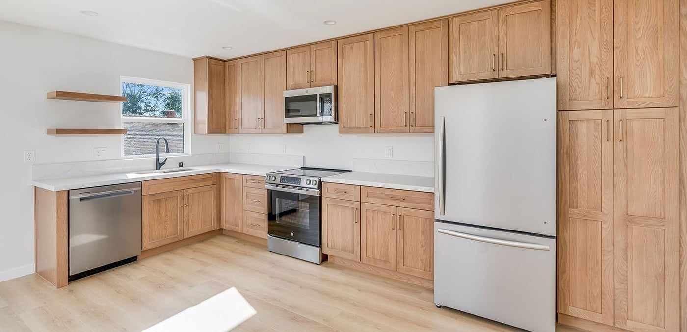 ADU kitchen with a tall pantry cabinet beside the refrigerator