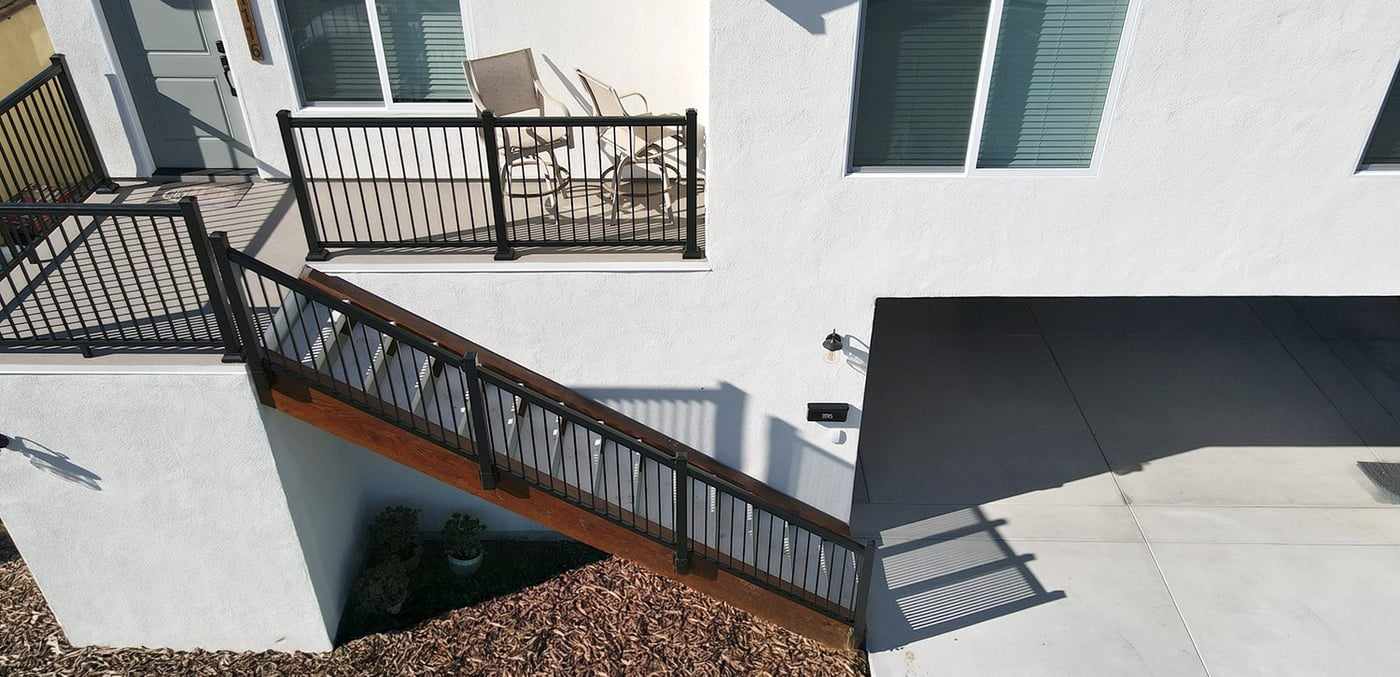 Aerial view of the deck, staircase and garage door below the attached ADU in Mira Mesa