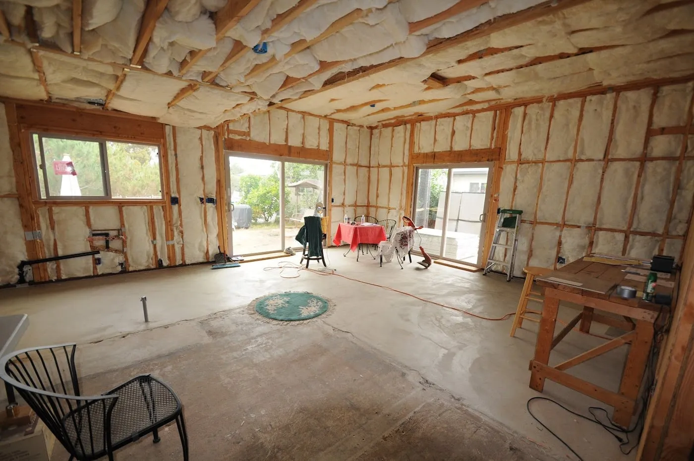 Room with open walls and new insulation in the ceiling during a remodel