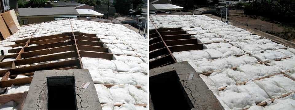 New attic insulation between the rafters, seen with the roof deck open