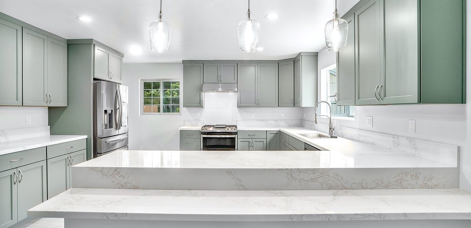 Clairemont kitchen remodel with sage green cabinets, quartz counters and glass pendant lights