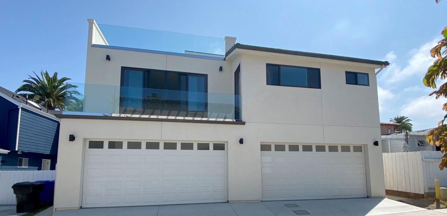 La Jolla whole home renovation with a new second story and glass balcony railings