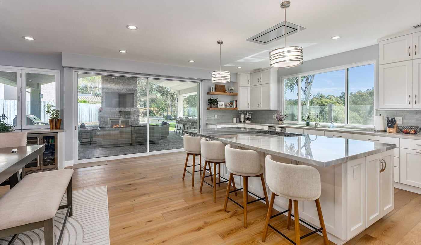 Kitchen island and family room, with the folding glass doors open to the patio
