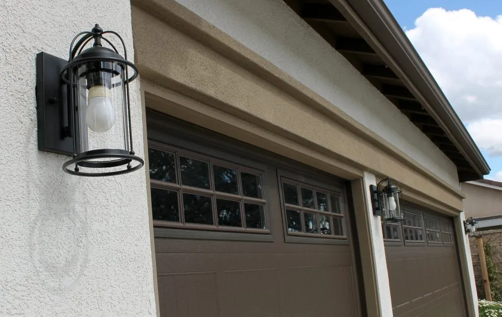 Exterior wall light beside a garage door
