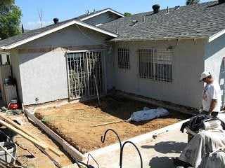 Foundation work for a room addition beside a single-story stucco home in San Diego