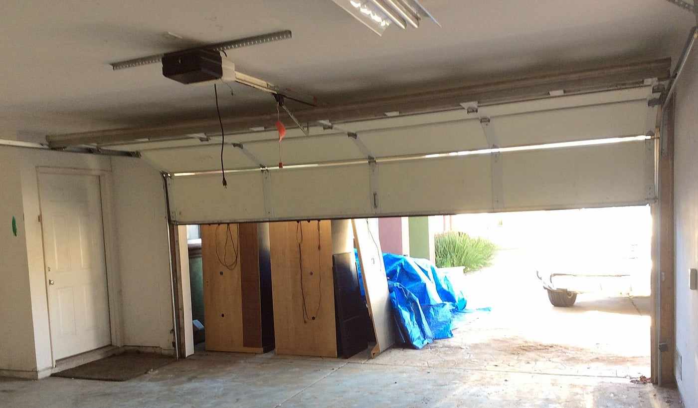 Garage interior before its conversion to an ADU, with the garage door open