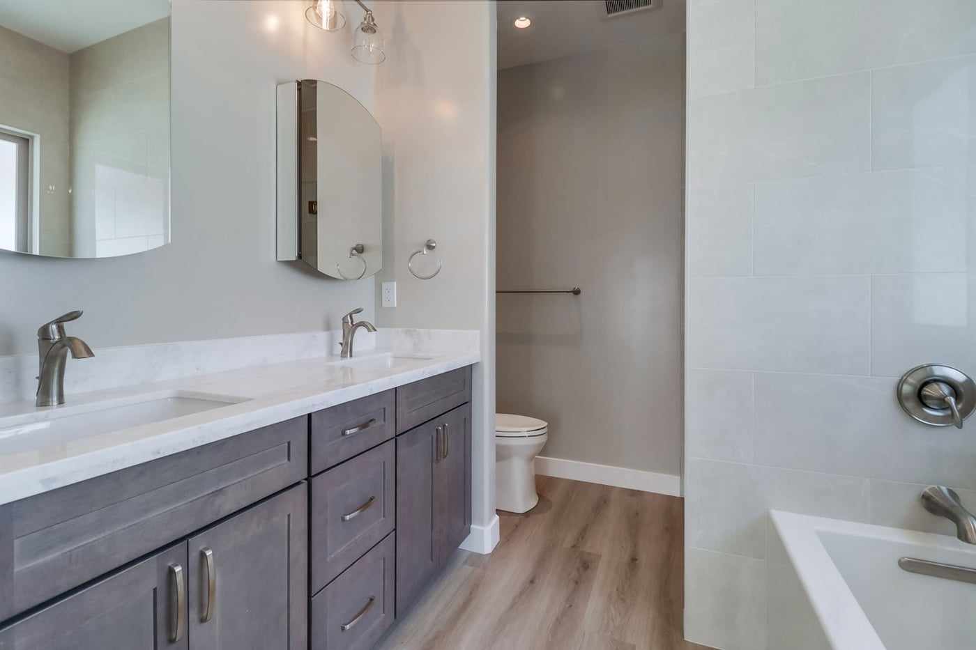 Bathroom in a primary suite addition, with a double vanity and a soaking tub