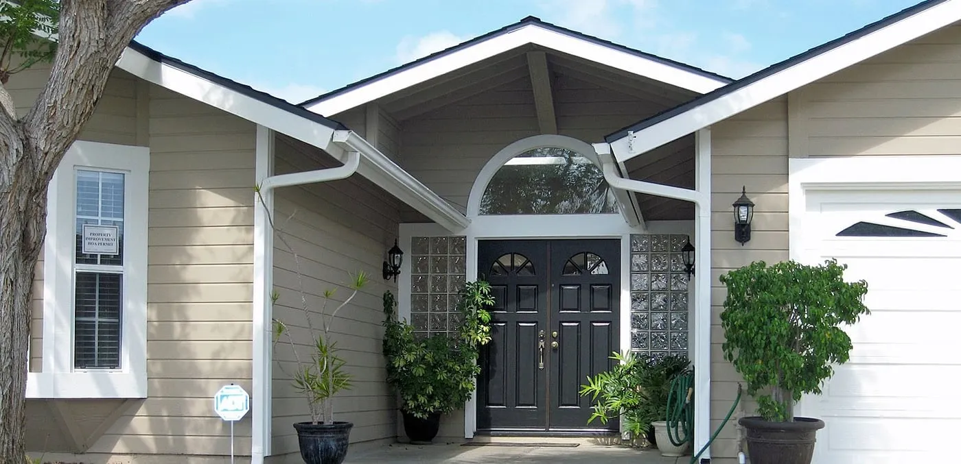 Front entry with double doors under a gabled porch roof