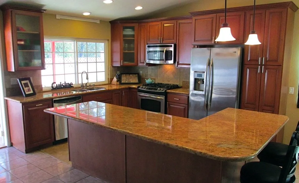 Open kitchen with cherry cabinets, granite counters and a large island