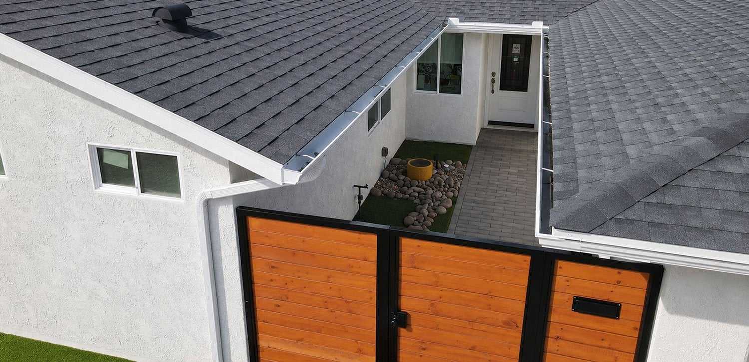 New gray shingle roof on a white stucco home