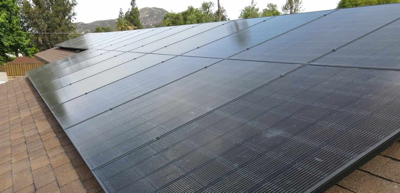 All-black solar panels on the shingle roof of a San Diego home