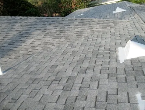 Finished shingle roof with low-profile roof vents