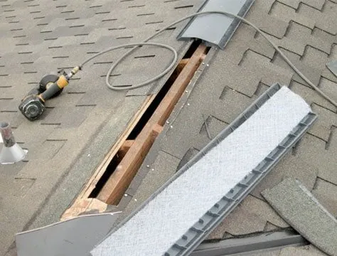 Ridge opened up for a ridge vent on a shingle roof