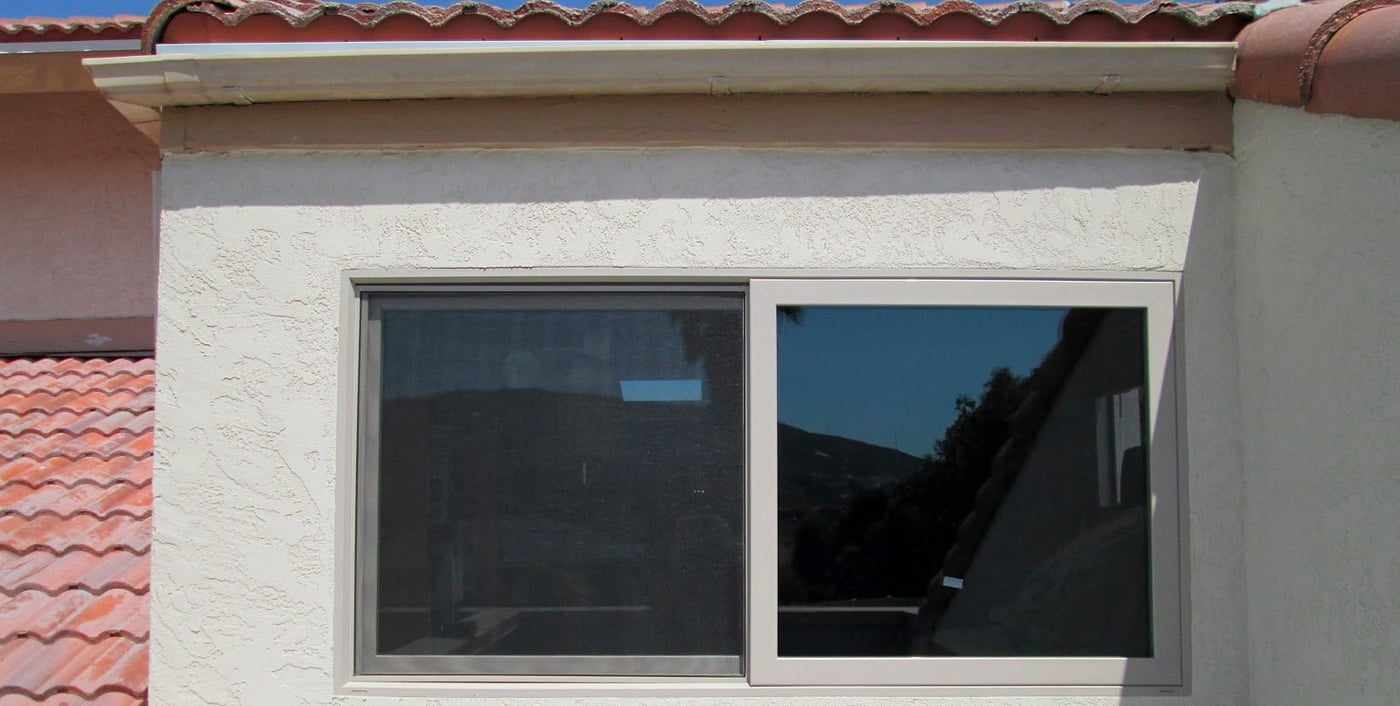The new sliding window in place on a San Diego home, with the stucco patched around it