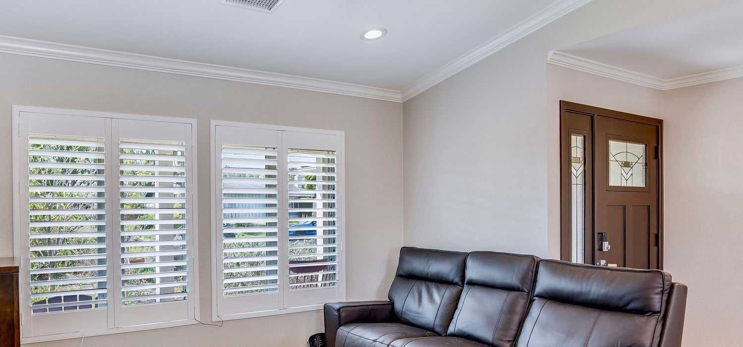 New living room windows with white plantation shutters